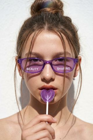 Women's portraits — Portrait with a lollipop and colored glasses
