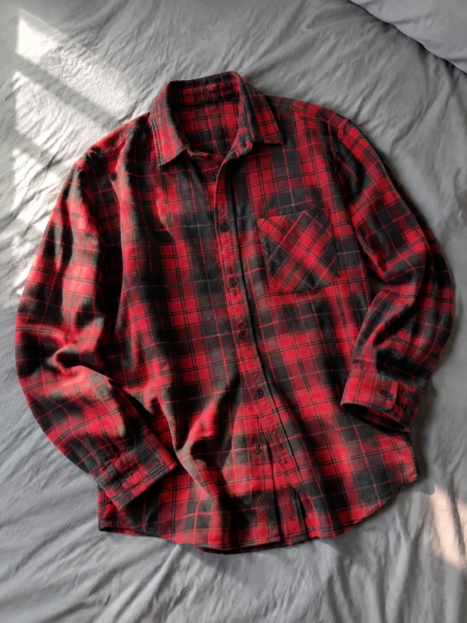 Original photo: plaid flannel shirt laid flat on a bed
