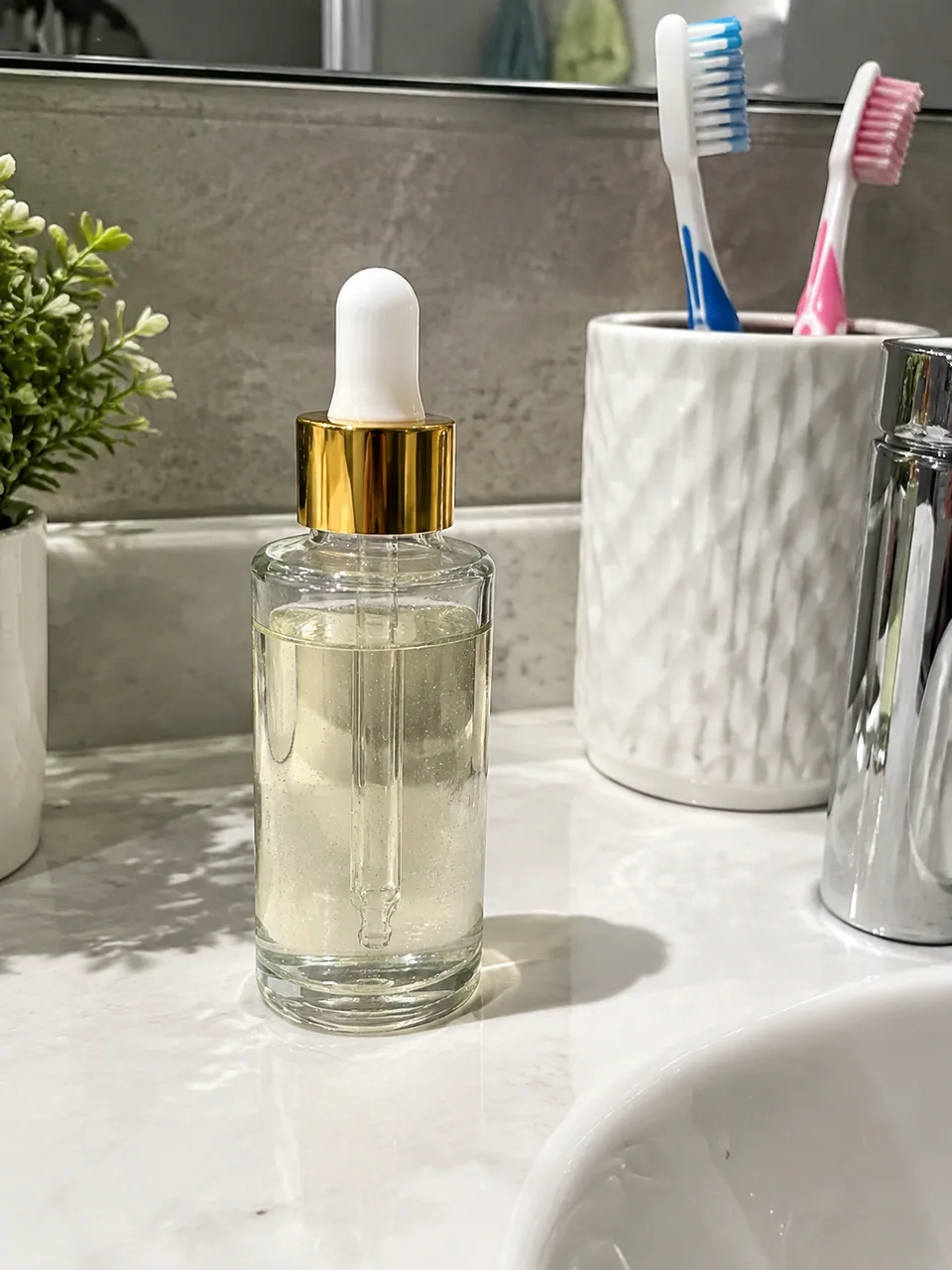 Original: serum bottle photographed on a cluttered bathroom sink