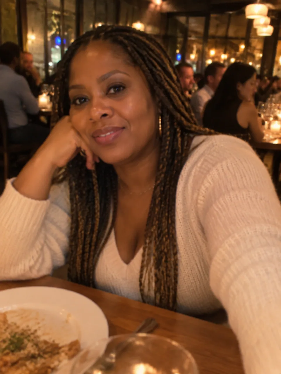 Original: dim restaurant snapshot of a woman in a casual sweater