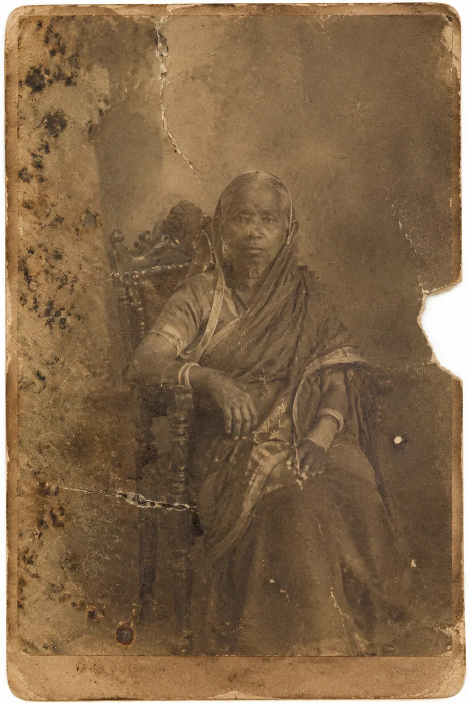 Original: cracked sepia portrait from the early 1900s with a missing edge