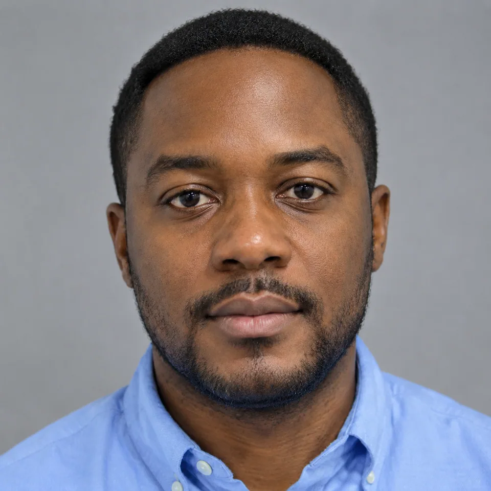 Enhanced headshot: balanced tone, matte skin, natural texture