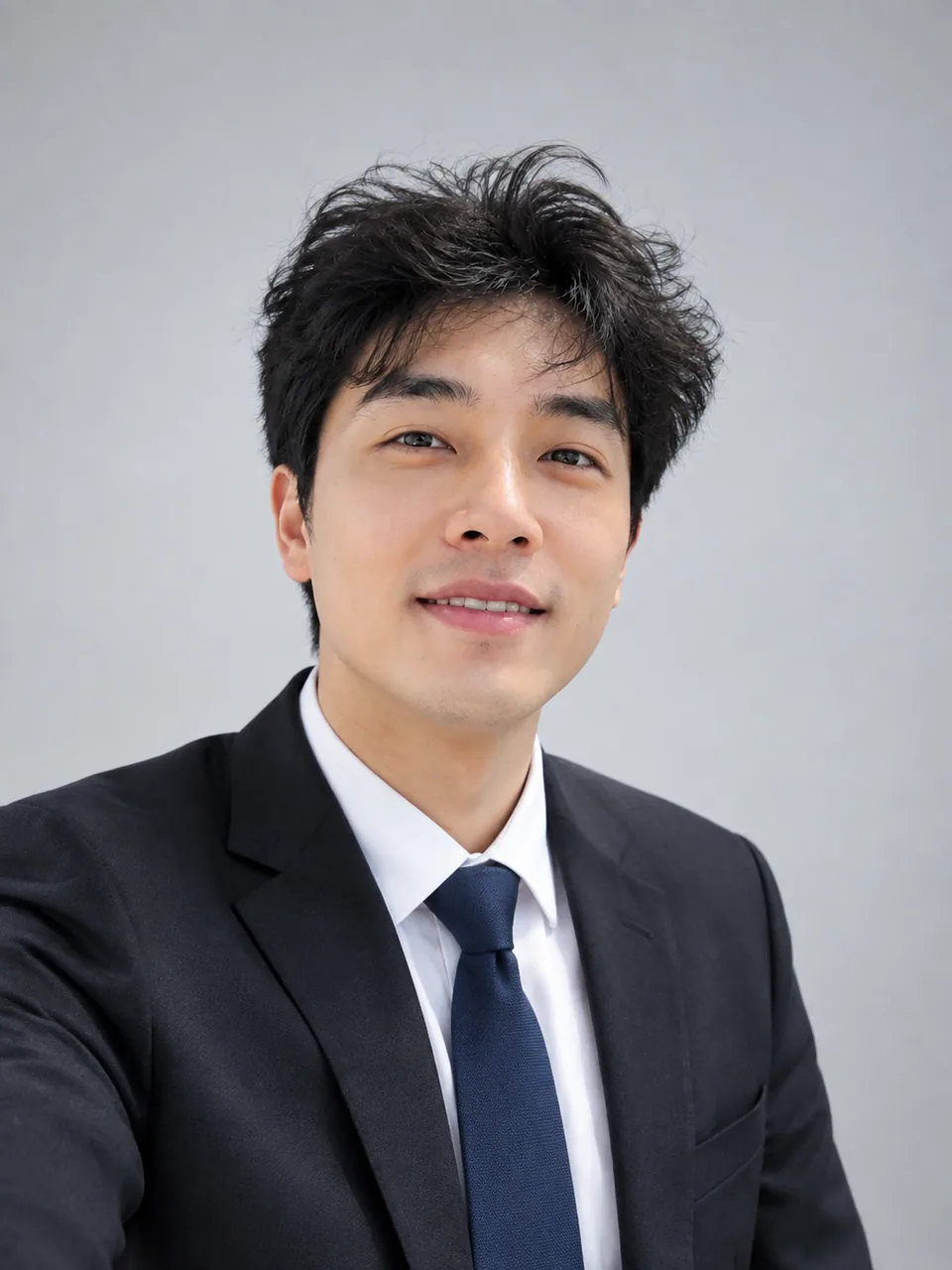 AI result: polished headshot of the same man in a blazer on a neutral backdrop